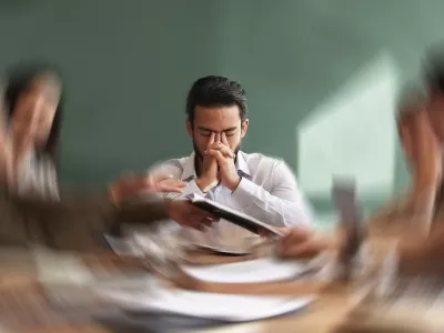 Stress, migraine and motion blur with a business man in a meeting feeling frustrated, tired or overworked. Mental health, anxiety and headache with an exhausted male employee suffering from fatigue