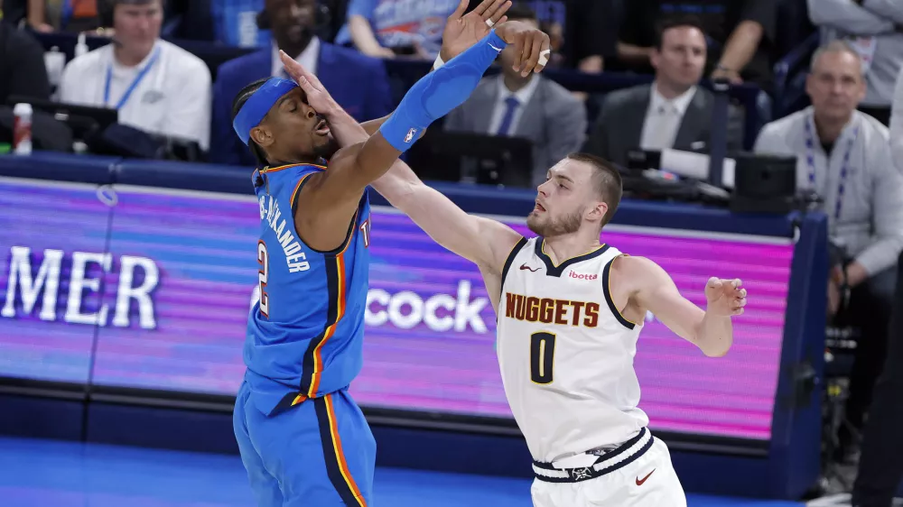 Mar 9, 2026; Oklahoma City, Oklahoma, USA; Oklahoma City Thunder guard Shai Gilgeous-Alexander (2) is hit in the face by Denver Nuggets guard Christian Braun (0) after shooting during the second half at Paycom Center. Mandatory Credit: Alonzo Adams-Imagn Images