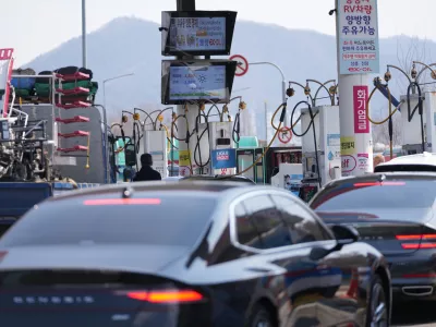 A man, center, fuels up a vehicle at a gas station in Seoul, South Korea, Tuesday, March 10, 2026. (AP Photo/Lee Jin-man)
