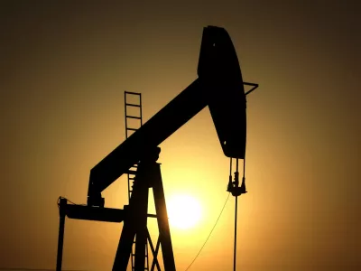 FILE- In this Wednesday, June 8, 2011 file photo, sun sets behind an oil pump in the desert oil fields of Sakhir, Bahrain. (AP Photo/Hasan Jamali, File)