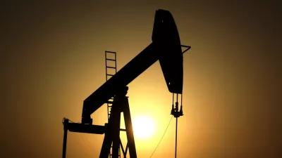 FILE- In this Wednesday, June 8, 2011 file photo, sun sets behind an oil pump in the desert oil fields of Sakhir, Bahrain. (AP Photo/Hasan Jamali, File)