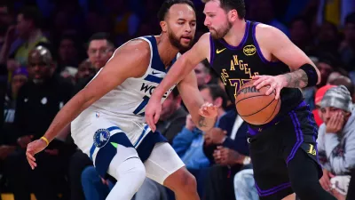 Mar 10, 2026; Los Angeles, California, USA; Los Angeles Lakers guard Luka Doncic (77) moves the ball against Minnesota Timberwolves forward Kyle Anderson (12) during the second half at Crypto.com Arena. Mandatory Credit: Gary A. Vasquez-Imagn Images
