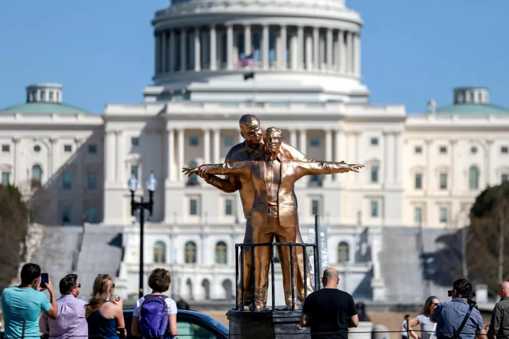 People look at a statue depicting U.S. President Donald Trump and convicted sex offender Jeffrey Epstein, entitled "The King of the World", on the National Mall in Washington, D.C., U.S., March 10, 2026. REUTERS/Evelyn Hockstein