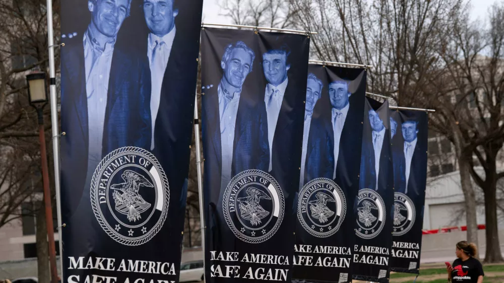Banners with a photograph of President Donald Trump and Jeffrey Epstein are seen on the National Mall, Wednesday, March 11, 2026, in Washington. (AP Photo/Jose Luis Magana)