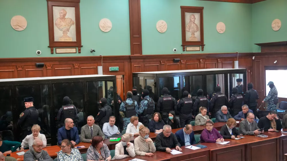 Men tried on the charges of involvement in a terror attack at the Crocus City Hall in March 2024 listen to the verdict in a glass cage at the Moscow City Court in Moscow, Russia, Thursday, March 12, 2026. (AP Photo/Pavel Bednyakov)