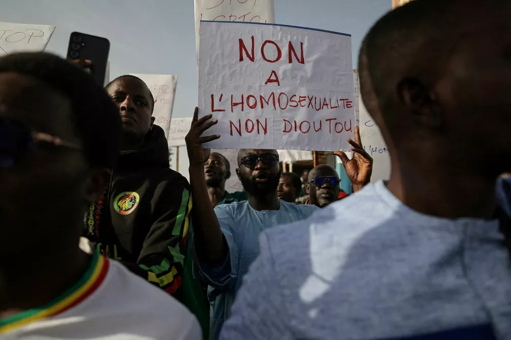 FILE PHOTO: Anti‑LGBT supporters march through the streets during a protest calling for tougher action after authorities detained people for what police said were crimes including same‑sex intercourse and intentional HIV transmission, and about a dozen others in what police said was a child‑abuse network, in Dakar, Senegal, February 14, 2026. REUTERS/Zohra Bensemra/File Photo