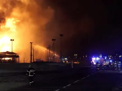Firefighters work at the site after reported Iranian strikes triggered fire at fuel tanks near the airport, in Muharraq, Bahrain March 12, 2026, in this screengrab taken from a handout video.  Bahrain Information Ministry/Handout via REUTERS  THIS IMAGE HAS BEEN SUPPLIED BY A THIRD PARTY. VERIFICATION: - Tanks, utility poles and buildings matched file and satellite imagery - Coordinates of the facility on fire: 26.26282799860747, 50.65329169205331 - Exact time not verified but no older version of the video was found posted online before March 12 - Bahrain's Ministry of Interior wrote on X that fuel tanks at a facility in Muharraq were targeted by Iranian forces on the morning of March 12
