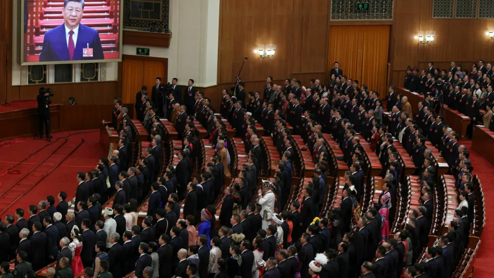 A screen shows Chinese President Xi Jinping as delegates sing the national anthem at the closing session of the National People's Congress (NPC) at the Great Hall of the People in Beijing, China March 12, 2026. REUTERS/Florence Lo