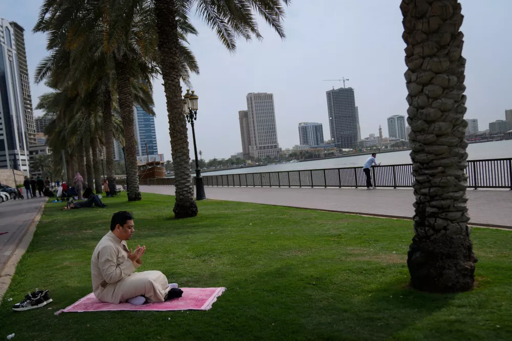 A Muslim man prays after attending the last Friday prayers of the holy fasting month of Ramadan outside Al Noor mosque in Sharjah, United Arab Emirates, Friday, March 13, 2026. (AP Photo/Altaf Qadri)