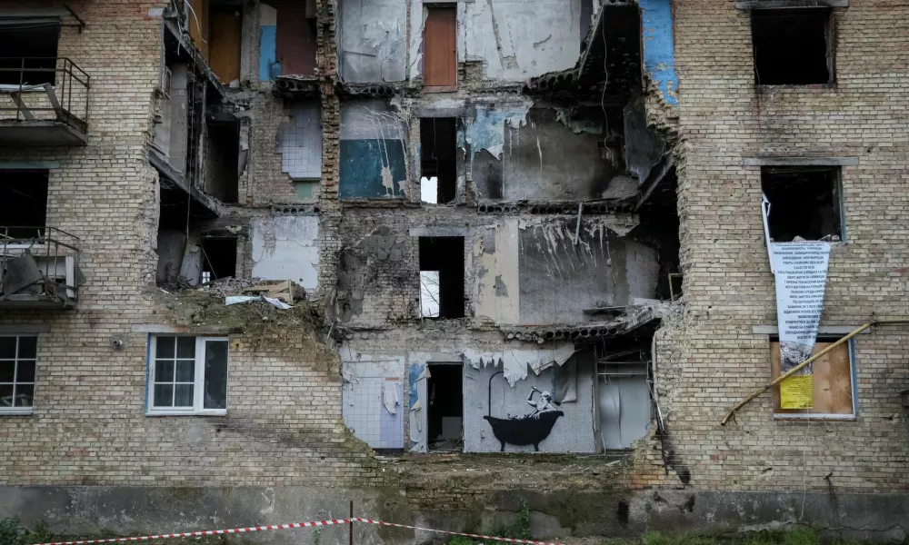 FILE PHOTO: A new graffiti in Banksy's signature style, although not posted by the mercurial artist on social media, is seen on the wall of a destroyed building in the Ukrainian village of Horenka, which had been occupied by Russia until April and heavily damaged by fighting in the early days of Russian invasion, November 13, 2022. REUTERS/Gleb Garanich