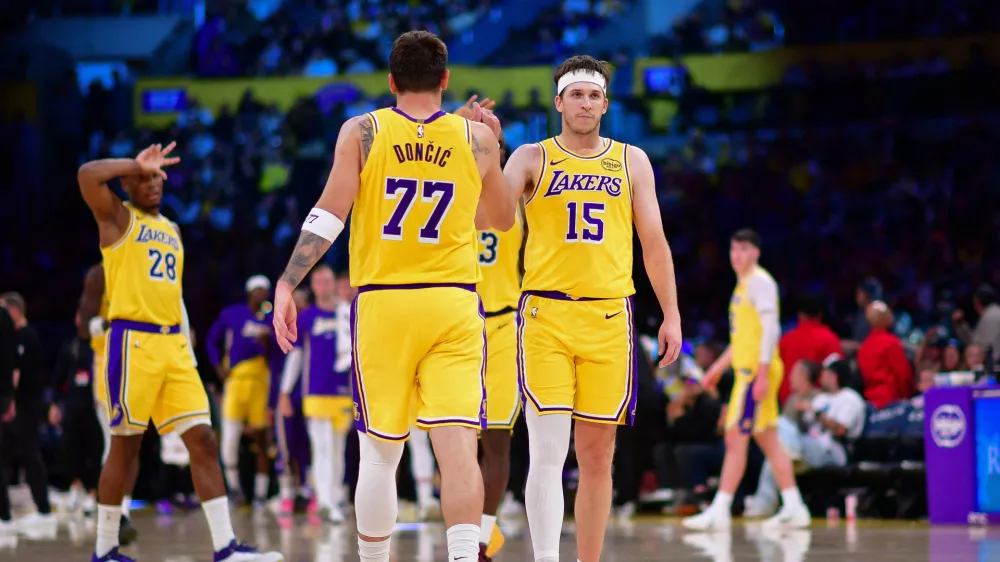 Mar 12, 2026; Los Angeles, California, USA; Los Angeles Lakers guard Luka Doncic (77) and guard Austin Reaves (15) react during the second half at Crypto.com Arena. Mandatory Credit: Gary A. Vasquez-Imagn Images