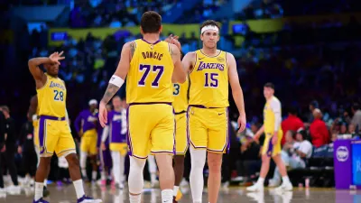 Mar 12, 2026; Los Angeles, California, USA; Los Angeles Lakers guard Luka Doncic (77) and guard Austin Reaves (15) react during the second half at Crypto.com Arena. Mandatory Credit: Gary A. Vasquez-Imagn Images