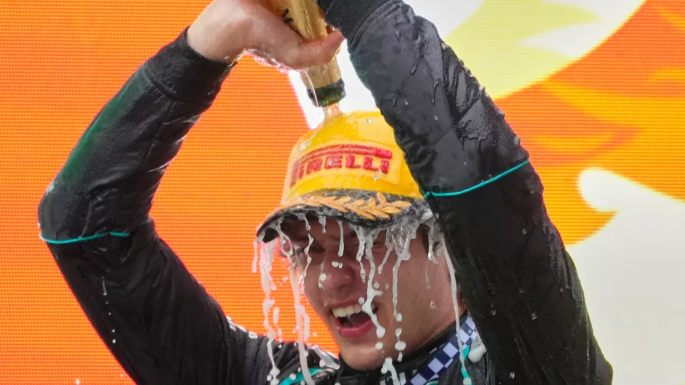 Race winner Mercedes driver Andrea Kimi Antonelli of Italy pours champagne on himself as he celebrates on the podium after the Chinese Formula One Grand Prix at the Shanghai International Circuit in Shanghai, China, Sunday, March 15, 2026. (AP Photo/Vincent Thian)
