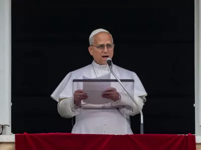 Pope Leo XIV appears at the window of his studio overlooking St. Peter's Square at the Vatican where Catholic faithful and pilgrims gathered for the traditional Sunday blessing at the end of the noon Angelus prayer, Sunday, March 15, 2026. (AP Photo/Andrew Medichini)