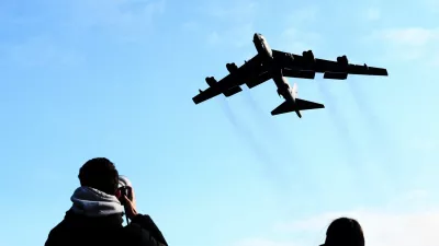 A plane spotter takes pictures as a U.S. Air Force Boeing B-52 Stratofortress takes off at RAF Fairford airbase, used by United States Air Force (USAF) personnel, amid the U.S.–Israeli conflict with Iran, in Fairford, Gloucestershire, Britain, March 15, 2026. REUTERS/Jack Taylo