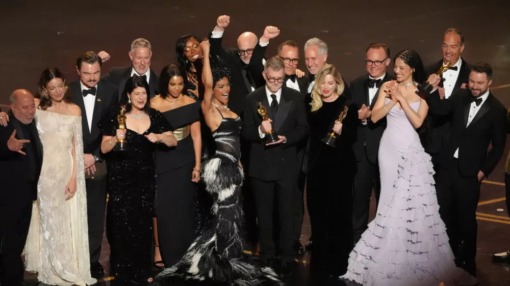 Jose Antonio Garcia, from left, Florencia Martin, Leonardo DiCaprio, Cassandra Kulukundis, Regina Hall, Shayna McHale, Teyana Taylor, Michael Bauman, Paul Thomas Anderson, Anthony Carlino, Will Weike, Sara Murphy, Chase Infiniti, Christopher Scarabosio, and Andy Jurgensen accept the award for best picture award for "One Battle After Another" during the Oscars on Sunday, March 15, 2026, at the Dolby Theatre in Los Angeles. (AP Photo/Chris Pizzello)