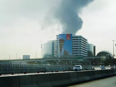 Smoke rising from the Dubai International Airport is seen through the windshield of a vehicle, after a drone attack hit a fuel tank, according to Dubai authorities, amid the U.S.-Israel conflict with Iran, in Dubai, United Arab Emirates, March 16, 2026, REUTERS/Stringer REFILE - QUALITY REPEAT