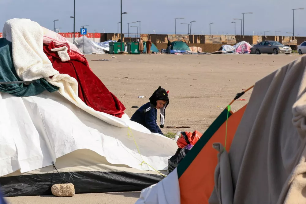 A displaced child outside a tent, following an escalation between Hezbollah and Israel, amid the U.S.-Israeli conflict with Iran, in Beirut, Lebanon, March 16, 2026. REUTERS/Raghed Waked