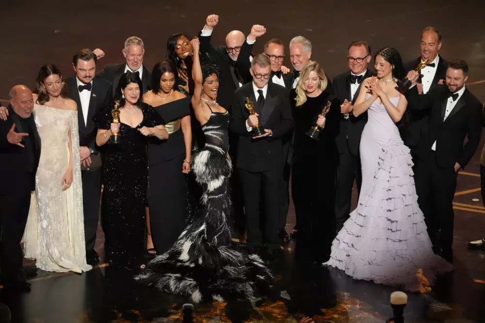 Jose Antonio Garcia, from left, Florencia Martin, Leonardo DiCaprio, Cassandra Kulukundis, Regina Hall, Shayna McHale, Teyana Taylor, Michael Bauman, Paul Thomas Anderson, Anthony Carlino, Will Weike, Sara Murphy, Chase Infiniti, Christopher Scarabosio, and Andy Jurgensen accept the award for best picture award for "One Battle After Another" during the Oscars on Sunday, March 15, 2026, at the Dolby Theatre in Los Angeles. (AP Photo/Chris Pizzello)
