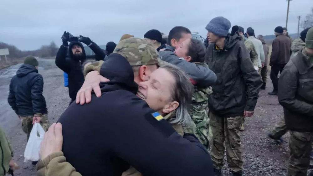 A woman embraces a Ukrainian prisoner of war (POWs) after a swap, amid Russia's attack on Ukraine, in an unknown location, Ukraine December 31, 2022. Head of Ukraine's Presidential Office Andriy Yermak via Telegram/Handout via REUTERS ATTENTION EDITORS - THIS IMAGE HAS BEEN SUPPLIED BY A THIRD PARTY. NO RESALES NO ARCHIVE.