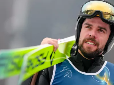 Johannes Rydzek, of Germany, makes his way to the ramp during the Nordic Combined Individual Gundersen Normal Hill/10km competition at the 2026 Winter Olympics, in Predazzo, Italy, Wednesday, Feb. 11, 2026. (AP Photo/Evgeniy Maloletka)