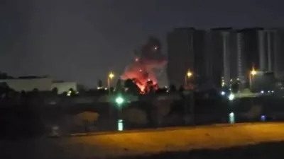 Smoke and fire rise during reported drone and rocket strikes at the U.S. embassy, according to Iraqi security sources, in Baghdad, Iraq, in this still image obtained from a social media video released on March 17, 2026. Social Media via REUTERS THIS IMAGE HAS BEEN SUPPLIED BY A THIRD PARTY. NO RESALES. NO ARCHIVES. NEWS USE ONLY. TPX IMAGES OF THE DAY    VERIFICATION: Reuters was able to confirm the location from buildings, road layout, water body, the construction crane and the pillar of the restaurant which matched file and satellite image. The strike happened within the vicinity of coordinates at 33.29897989833943, 44.38517051381258. Exact time was not verified but no older version of the video was found posted online before March 17. Security sources confirmed that drones and rockets attacked the US embassy in Baghdad on March 17.