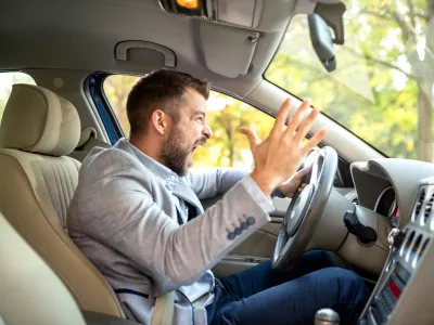 Really angry driver behind the steering wheel cannot keep his calmness