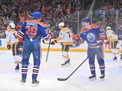 Mar 15, 2026; Edmonton, Alberta, CAN; Edmonton Oilers center Leon Draisaitl (29) and Oilers left wing Zach Hyman (18) celebrate a goal on Nashville Predators goalie Justus Annunen (29) during the first period at Rogers Place. Mandatory Credit: Walter Tychnowicz-Imagn Images