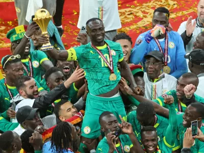 FILE - Senegal's Sadio Mane holds the trophy aloft as he celebrates with teammates after winning the Africa Cup of Nations final soccer match between Senegal and Morocco in Rabat, Morocco, Sunday, Jan. 18, 2026. (AP Photo/Youssef Loulidi, File)