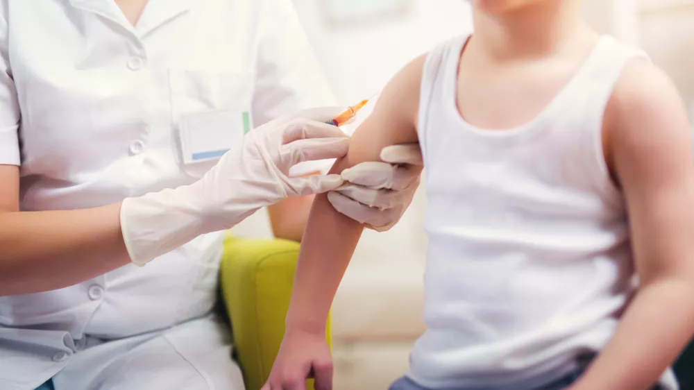 Pediatrician makes vaccination to small boy