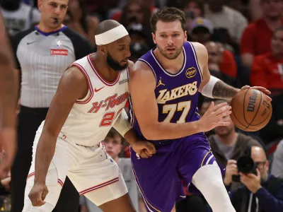 Mar 18, 2026; Houston, Texas, USA; Los Angeles Lakers guard Luka Doncic (77) leans on Houston Rockets guard Josh Okogie (20) in the second quarter at Toyota Center. Mandatory Credit: Thomas Shea-Imagn Images