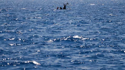 FILE-- Migrants from Syria and Libya in a wooden boat call for help as they are assisted by Spanish NGO Open Arms during a rescue operation inside Malta's SAR zone south of the Italian island of Lampedusa in the Mediterranean Sea, Wednesday, Aug. 10, 2022. (AP Photo/Francisco Seco)