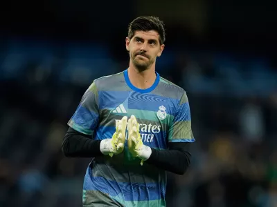 Real Madrid's goalkeeper Thibaut Courtois enters the pitch to warm up for the Champions League round of 16 second leg soccer match between Manchester City and Real Madrid in Manchester, Tuesday, March 17, 2026. (AP Photo/Dave Thompson)