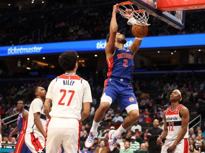Mar 17, 2026; Washington, District of Columbia, USA; Detroit Pistons guard Cade Cunningham (2) dunks over Washington Wizards guard Will Riley (27) and guard Tre Johnson (12) during the first half at Capital One Arena. Mandatory Credit: Daniel Kucin Jr.-Imagn Images