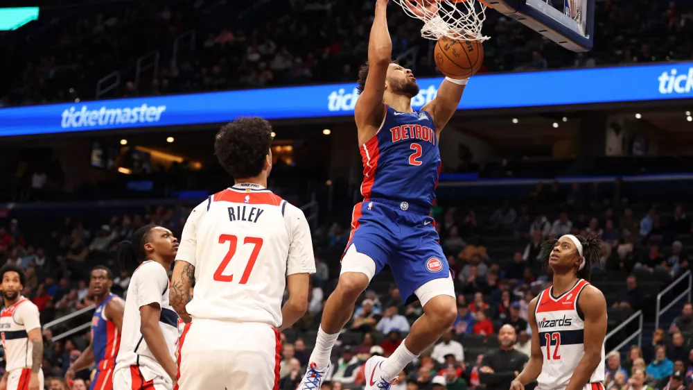 Mar 17, 2026; Washington, District of Columbia, USA; Detroit Pistons guard Cade Cunningham (2) dunks over Washington Wizards guard Will Riley (27) and guard Tre Johnson (12) during the first half at Capital One Arena. Mandatory Credit: Daniel Kucin Jr.-Imagn Images