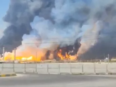 Smoke and fire rise near the South Pars gas field following an attack, amid the U.S.-Israeli conflict with Iran, in Bushehr Province, Iran, March 18, 2026, in this screengrab obtained from a social media video. Social Media/via REUTERS THIS IMAGE HAS BEEN SUPPLIED BY A THIRD PARTY. NO RESALES. NO ARCHIVES. NEWS ONLY USE.  VERIFICATION: Reuters confirmed the location from the road layout, light house, electric pylons, and ship model. Reuters could not confirm the date of footage, however Iran's Fars news agency reported that gas tanks and parts of a refinery had been hit and state media later said the fire there was under control. No older versions of the video were found before March 18. Coordinates of the structures under fire was seen from 27.525170402738087, 52.572015374827416. NASA FIRMS detected thermal activity in the vicinity on March 18.  Iranian gas flows to Iraq were halted on Wednesday following an attack on Iran's Pars gas field, a senior Iraqi official told Reuters.