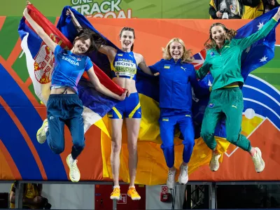 Angelina Topic, of Serbia, Yaroslava Mahuchikh, of Ukraine, Yuliia Levchenko, of Ukraine, and Nicola Olyslagers, of Australia, from left, jump for a winners photo after the women's high jump final at the World Athletics Indoor Championships in Torun, Poland, Friday, March 20, 2026. (AP Photo/Matthias Schrader)