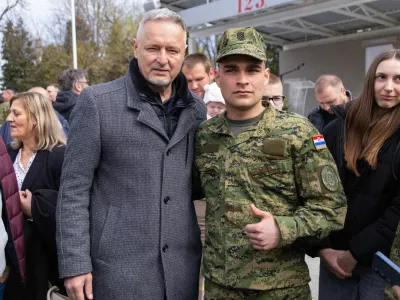 Army cadet takes a picture with singer Marko Perkovic Thompson after the ceremonial oath in barracks of the 123rd Croatian Army Brigade in Pozega, March 20, 2026. REUTERS/Antonio Bronic