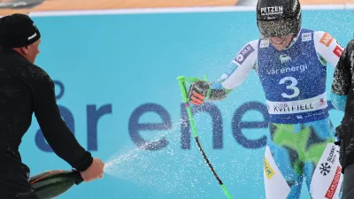 Slovenia's Ilka Stuhec celebrates her retirement at the finish area of an alpine ski, women's super-G race, at the Lillehammer World Cup Finals, in Kvitfjell, Norway, Sunday, March 22, 2026. (AP Photo/Marco Trovati)
