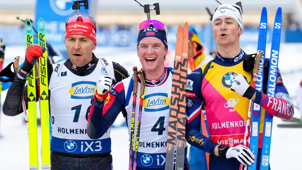 From left, second placed Germany's Philipp Nawrath, first placed Johan-Olav Smordal Botn and third placed Eric Perrot from France pose for a photo after the men's 15 km mass start event at the Biathlon World Cup in Holmenkollen, near Oslo, Norway, Sunday, March 22, 2026. (Heiko Junge/NTB Scanpix via AP)