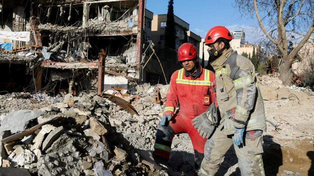 Members of a Red Crescent rescue team work at a building that was damaged by a strike, amid the U.S.-Israeli conflict with Iran, in Tehran, Iran, March 21, 2026. Reuters/Alaa Al-Marjani