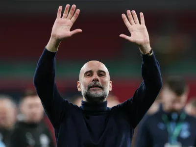 Soccer Football - Carabao Cup - Final - Arsenal v Manchester City - Wembley Stadium, London, Britain - March 22, 2026 Manchester City manager Pep Guardiola celebrates winning the Carabao Cup Action Images via Reuters/Paul Childs EDITORIAL USE ONLY. NO USE WITH UNAUTHORIZED AUDIO, VIDEO, DATA, FIXTURE LISTS, CLUB/LEAGUE LOGOS OR 'LIVE' SERVICES. ONLINE IN-MATCH USE LIMITED TO 120 IMAGES, NO VIDEO EMULATION. NO USE IN BETTING, GAMES OR SINGLE CLUB/LEAGUE/PLAYER PUBLICATIONS. PLEASE CONTACT YOUR ACCOUNT REPRESENTATIVE FOR FURTHER DETAILS..