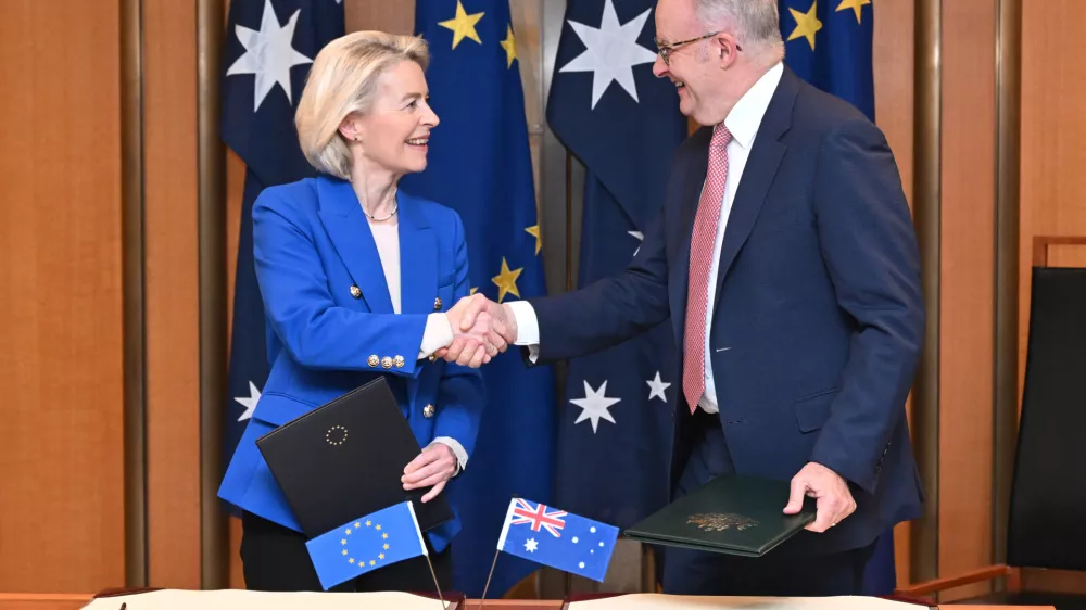 European Commission President Ursula von der Leyen, left, and Australian Prime Minister Anthony Albanese shake hands after signing a joint statement during a ceremony at Parliament House in Canberra, Tuesday, March 24, 2026. (Lukas Coch/AAP Image via AP)