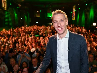 Dominik Krause, right, top candidate of the Green party, on stage at the Green Party election party after the run-off election for the office of Lord Mayor in the Bavarian capital of Munich, Germany, Sunday, March 22, 2026. (Sven Hoppe/dpa via AP)