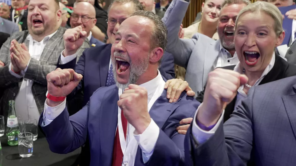 The AfD's top canditate Jan Bollinger, front, and Alice Weidel, right, chairwoman of the Alternative for Germany party (AfD) parliamentary group, celebrate in Mainz, Germany, Sunday, March 22, 2026, after the forecast of the results of the German state election in Rhineland-Palatinate. (Andreas Arnold/dpa via AP)