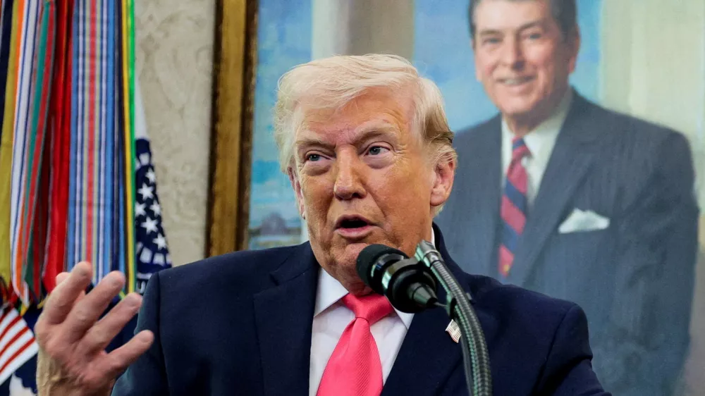 U.S. President Donald Trump speaks, with a portrait of former U.S. President Ronald Reagan in the background, as he attends Markwayne Mullin's swearing-in as Department of Homeland Security (DHS) Secretary, at the White House in Washington, D.C., U.S., March 24, 2026. REUTERS/Evan Vucci   TPX IMAGES OF THE DAY