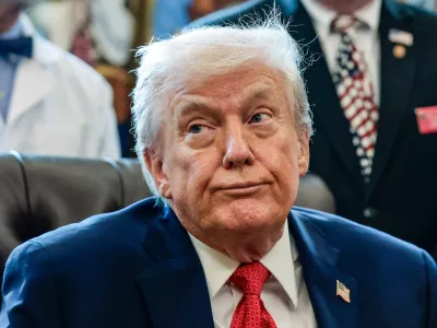 U.S. President Donald Trump looks on as he signs an executive order recommending loosening the federal regulations on marijuana, in the Oval Office at the White House in Washington, D.C., U.S., December 18, 2025. REUTERS/Evelyn Hockstein   TPX IMAGES OF THE DAY