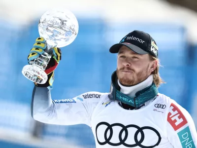Norway's Atle Lie McGrath holds the globe trophy for the alpine ski, men's slalom discipline, at the Lillehammer World Cup Finals, in Hafjell, Norway, Wednesday, March 25, 2026. (AP Photo/Gabriele Facciotti)