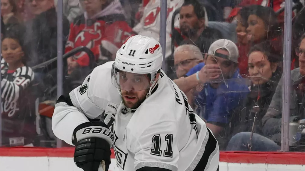 Mar 14, 2026; Newark, New Jersey, USA; Los Angeles Kings center Anze Kopitar (11) passes the puck against the New Jersey Devils during the first period at Prudential Center. Mandatory Credit: Ed Mulholland-Imagn Images
