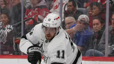 Mar 14, 2026; Newark, New Jersey, USA; Los Angeles Kings center Anze Kopitar (11) passes the puck against the New Jersey Devils during the first period at Prudential Center. Mandatory Credit: Ed Mulholland-Imagn Images